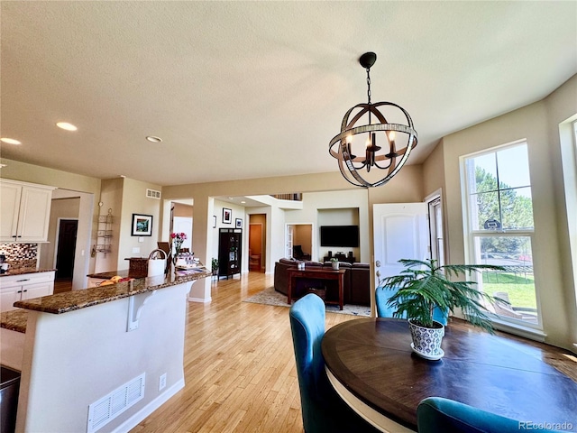 2896 Gemini Loop, Broomfield, CO 80023 - dining room with a chandelier, light wood finished floors, recessed lighting, and a textured ceiling