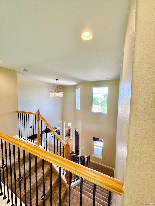 2896 Gemini Loop, Broomfield, CO 80023 - stairway featuring a chandelier, carpet flooring, recessed lighting, and a textured wall