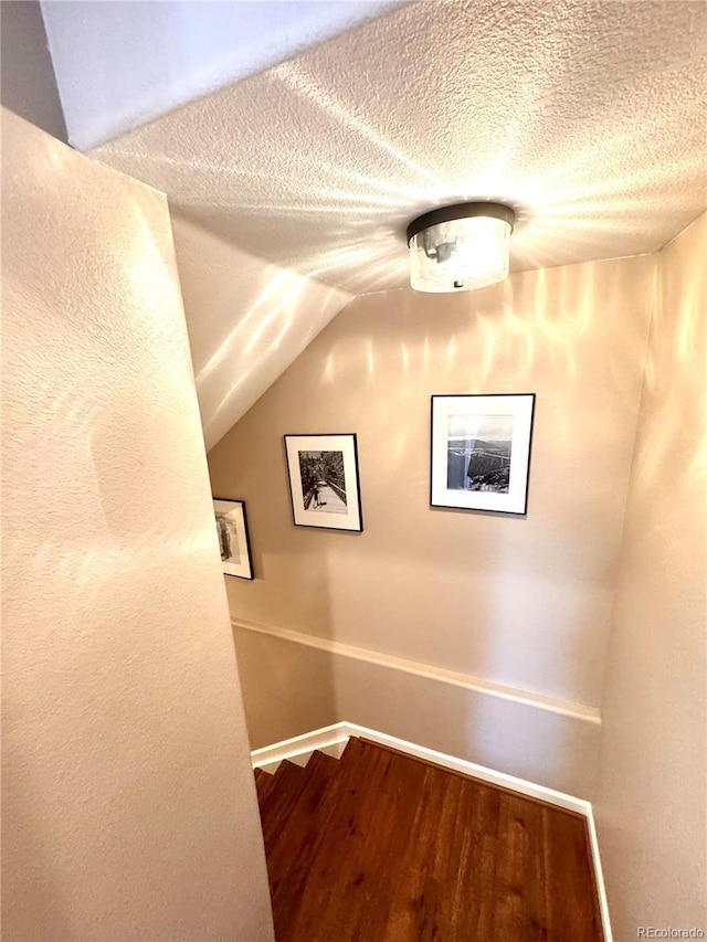 2896 Gemini Loop, Broomfield, CO 80023 - stairway with wood finished floors, vaulted ceiling, and a textured ceiling