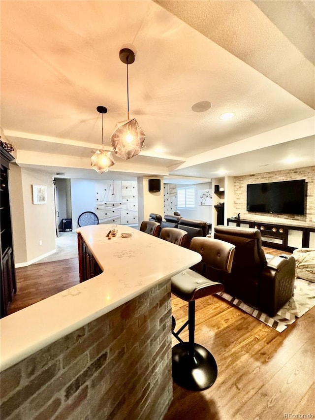 2896 Gemini Loop, Broomfield, CO 80023 - kitchen featuring wood finished floors, hanging light fixtures, open floor plan, and light countertops