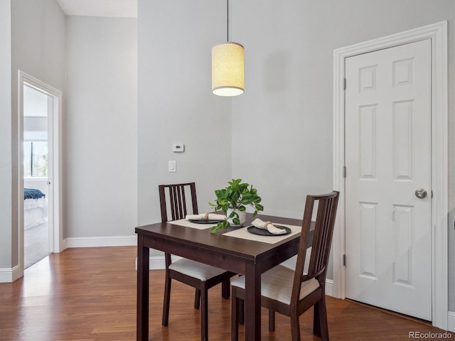 dining room featuring wood finished floors and baseboards