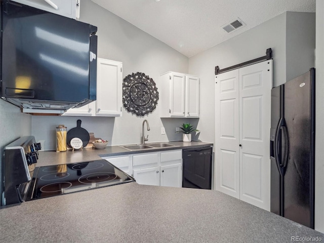 kitchen with black appliances, a sink, white cabinets, vaulted ceiling, and a textured ceiling