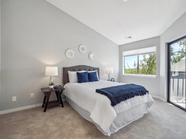 carpeted bedroom featuring access to exterior, baseboards, and a textured ceiling