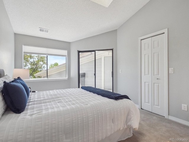 carpeted bedroom featuring baseboards and a textured ceiling