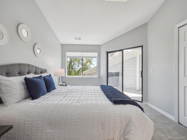 carpeted bedroom with access to outside, a textured ceiling, and baseboards