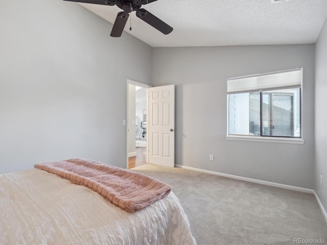 bedroom featuring lofted ceiling, carpet floors, baseboards, and ceiling fan