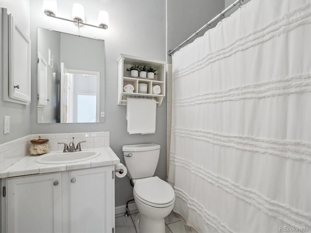 full bath featuring toilet and vanity