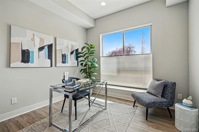home office featuring baseboards and wood finished floors