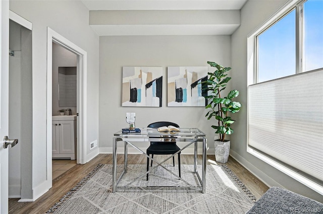office area with baseboards and wood finished floors