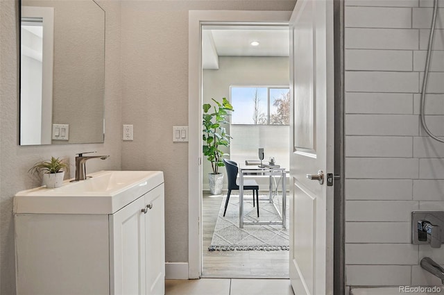 bathroom with vanity and baseboards