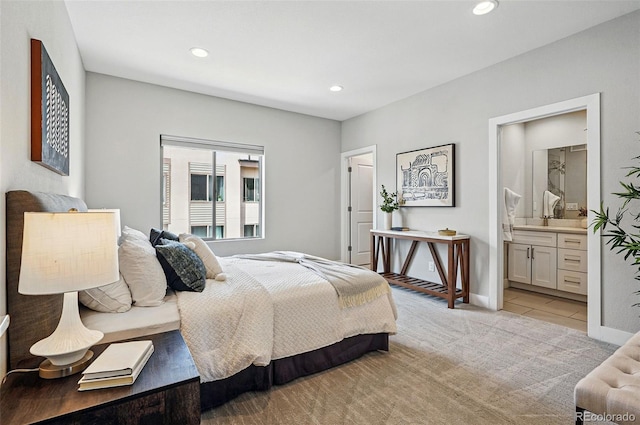 bedroom with ensuite bath, baseboards, recessed lighting, and light tile patterned flooring