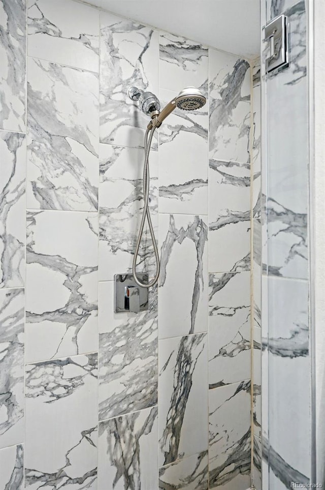 bathroom with tiled shower