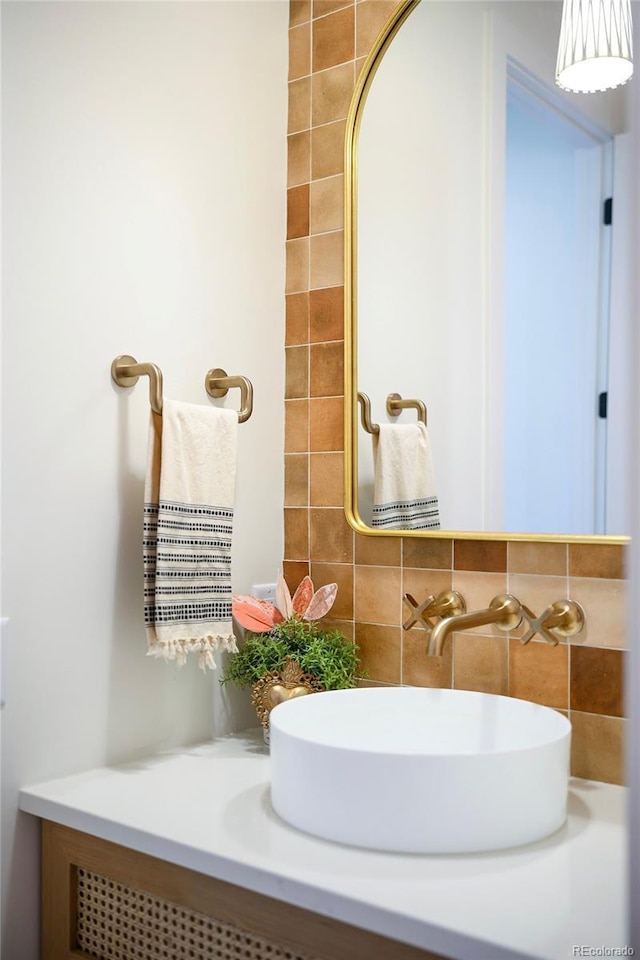 bathroom featuring tasteful backsplash and vanity