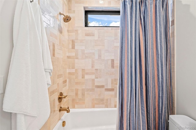 bathroom featuring shower / bath combination with curtain and toilet