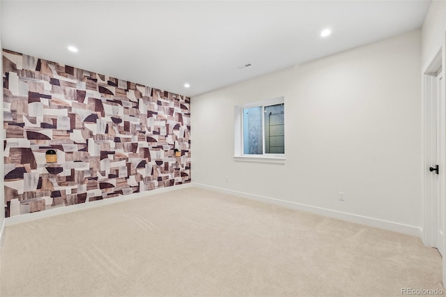 carpeted empty room with recessed lighting, visible vents, and baseboards