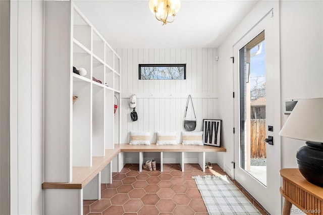 mudroom featuring a chandelier, plenty of natural light, and tile patterned floors