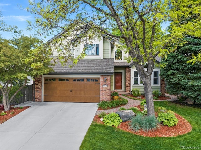 8040 W 78th Cir, Arvada, CO 80005 - view of front of house with brick siding, an attached garage, concrete driveway, and a shingled roof