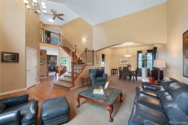 8040 W 78th Cir, Arvada, CO 80005 - living area featuring a high ceiling, arched walkways, stairs, healthy amount of natural light, and a chandelier