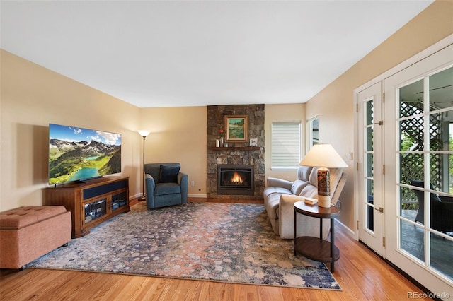 8040 W 78th Cir, Arvada, CO 80005 - living room with wood finished floors, a fireplace, healthy amount of natural light, and baseboards