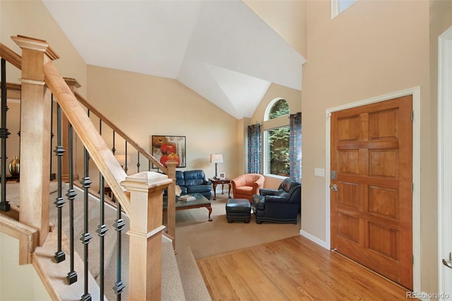 8040 W 78th Cir, Arvada, CO 80005 - foyer featuring wood finished floors, stairway, baseboards, and high vaulted ceiling