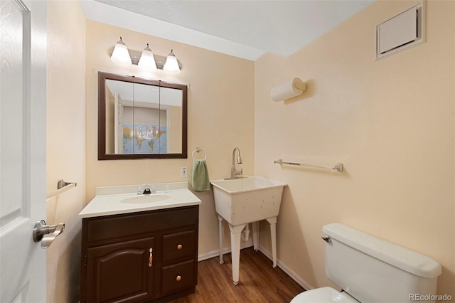 8040 W 78th Cir, Arvada, CO 80005 - half bath with a sink, toilet, wood finished floors, and baseboards