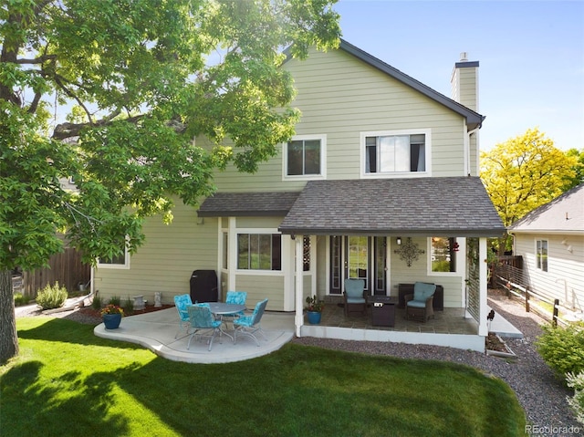 8040 W 78th Cir, Arvada, CO 80005 - back of house with a patio, a chimney, an outdoor living space, and a shingled roof