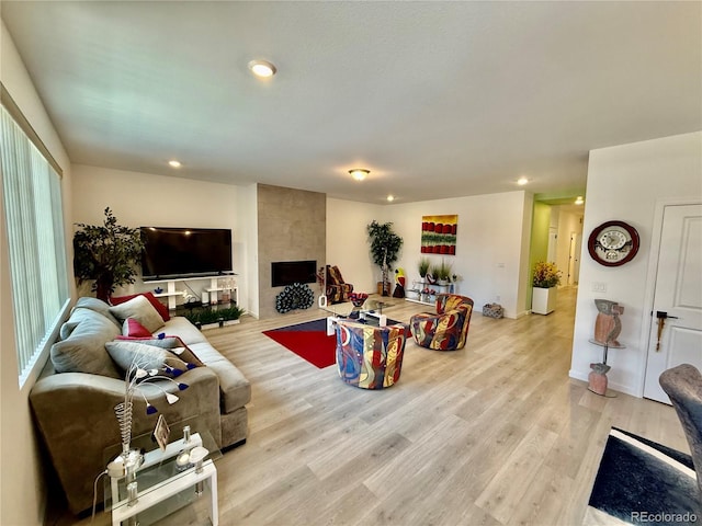 27580 E Cedar Pl, Aurora, CO 80018 - living room with recessed lighting, light wood finished floors, and a tiled fireplace