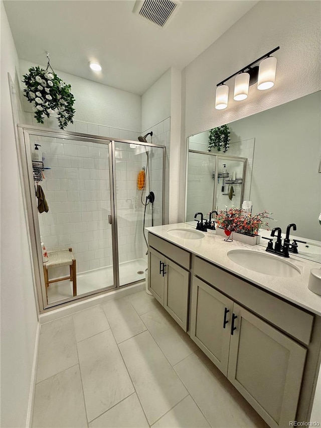 27580 E Cedar Pl, Aurora, CO 80018 - bathroom with a stall shower, double vanity, and tile patterned floors