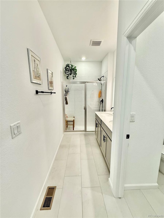 27580 E Cedar Pl, Aurora, CO 80018 - full bath with a shower stall, double vanity, and tile patterned floors
