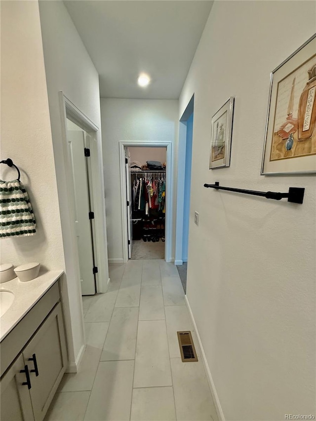 27580 E Cedar Pl, Aurora, CO 80018 - corridor with baseboards and light tile patterned floors