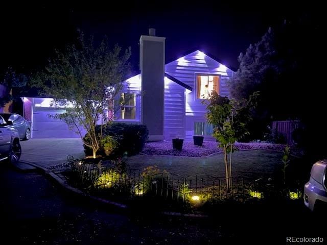 1102 Conifer Ct, Highlands Ranch, CO 80126 - property exterior at night with a chimney