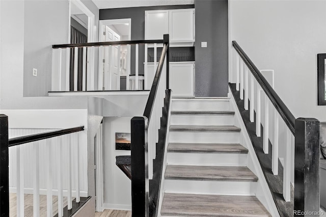1102 Conifer Ct, Highlands Ranch, CO 80126 - stairs featuring wood finished floors