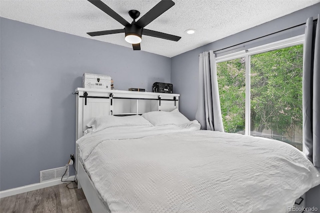 1102 Conifer Ct, Highlands Ranch, CO 80126 - bedroom with wood finished floors, a textured ceiling, and a ceiling fan