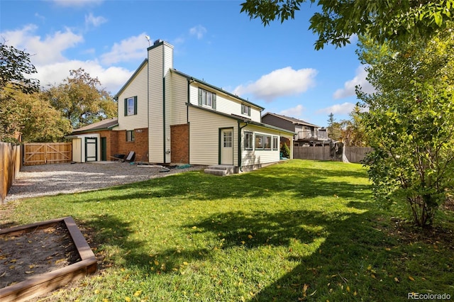 rear view of property featuring a yard