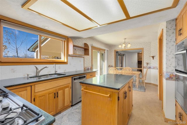 kitchen featuring sink, light colored carpet, a textured ceiling, a kitchen island, and appliances with stainless steel finishes