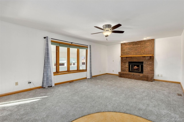 unfurnished living room featuring carpet, ceiling fan, and a brick fireplace