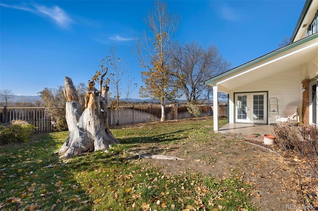 view of yard with french doors and a patio