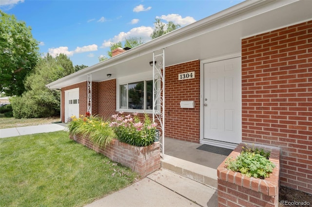 1304 S Lemay Ave, Fort Collins, CO 80524 - doorway to property with an attached garage, brick siding, driveway, a yard, and a chimney