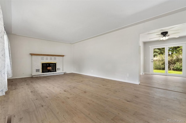 1304 S Lemay Ave, Fort Collins, CO 80524 - unfurnished living room featuring wood finished floors, ceiling fan, and a fireplace