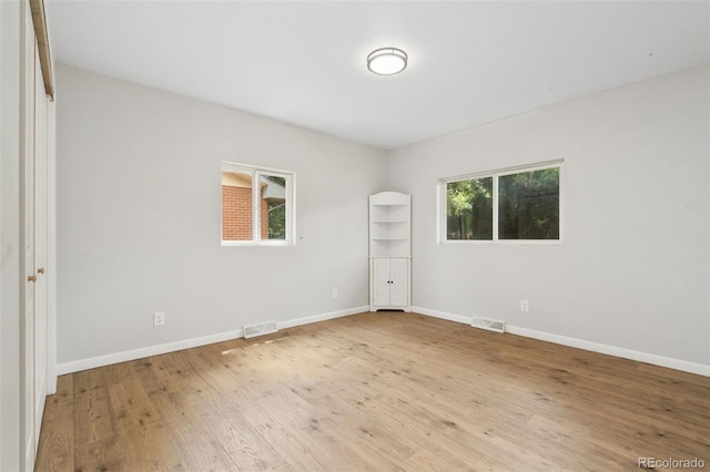 1304 S Lemay Ave, Fort Collins, CO 80524 - unfurnished bedroom featuring multiple windows and wood finished floors