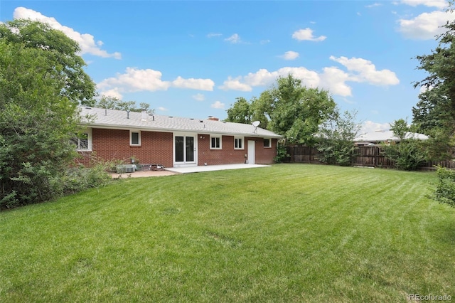 1304 S Lemay Ave, Fort Collins, CO 80524 - rear view of property featuring a patio area, brick siding, and a chimney