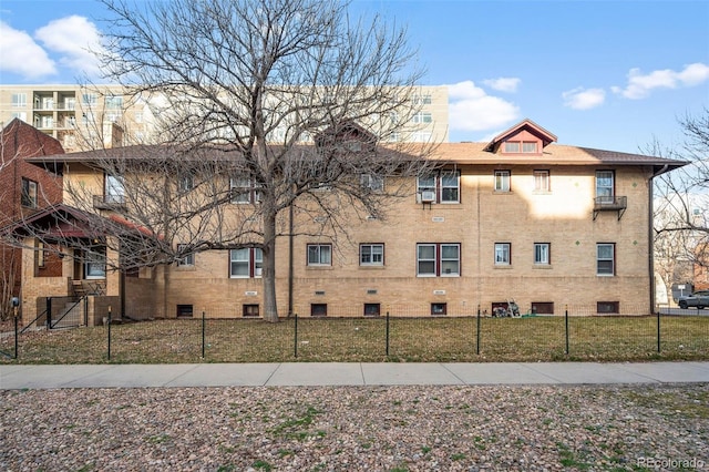 view of building exterior with a fenced front yard