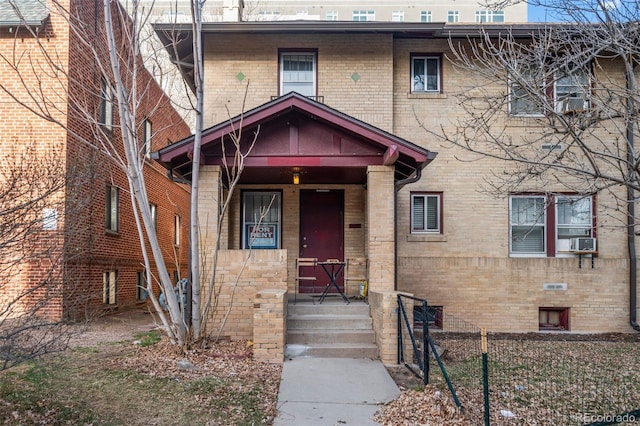 view of front facade featuring brick siding and cooling unit