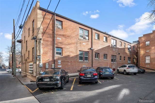 view of building exterior with uncovered parking