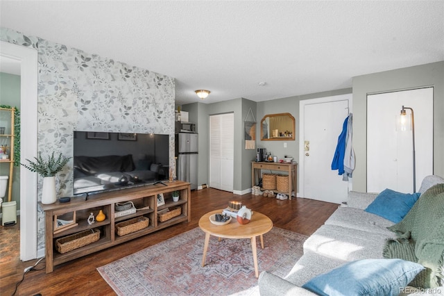 living area featuring a textured ceiling and wood finished floors