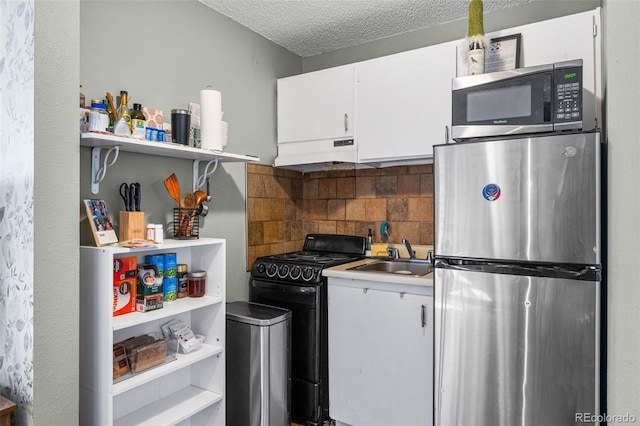 kitchen featuring tasteful backsplash, a sink, under cabinet range hood, appliances with stainless steel finishes, and open shelves