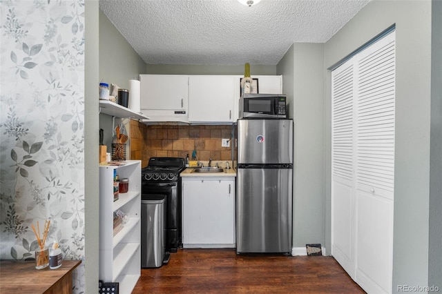 kitchen with dark wood finished floors, white cabinets, appliances with stainless steel finishes, and open shelves