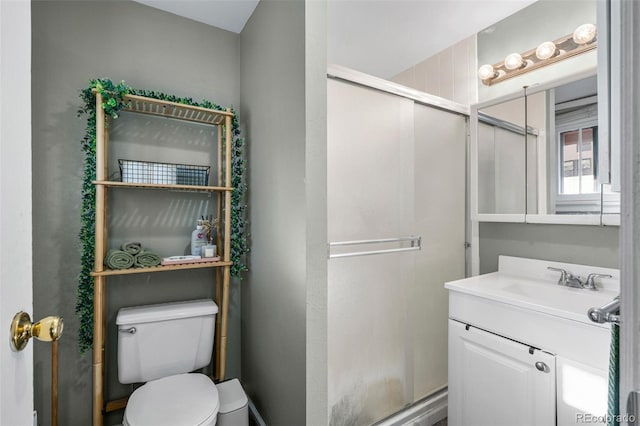 full bathroom with a shower stall, toilet, and vanity