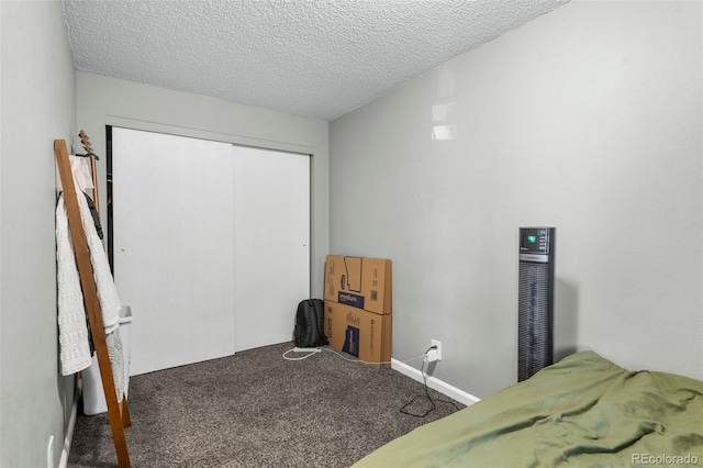 carpeted bedroom with a closet and a textured ceiling