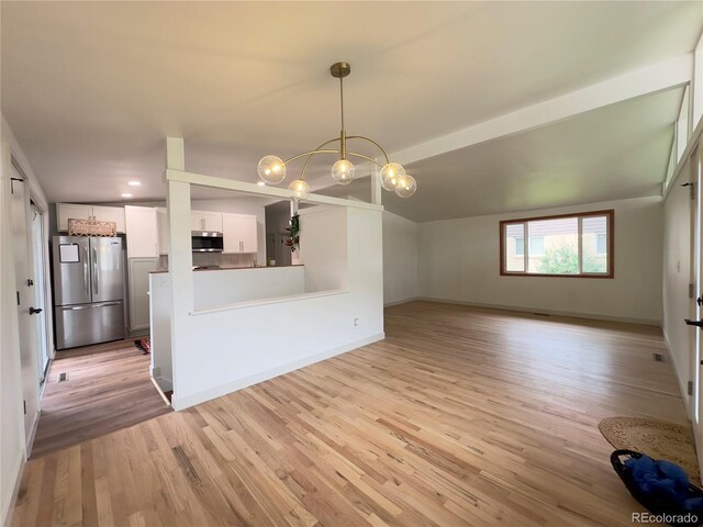 3355 Moorhead Ave, Boulder, CO 80305 - unfurnished living room with a chandelier, light wood-type flooring, baseboards, and vaulted ceiling